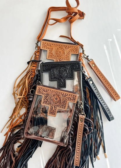 Brown leather crossbody bag with decorative patterns and fringes on a white background