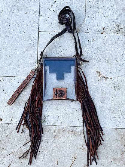 Bag with fringes and a blue interior on a textured surface