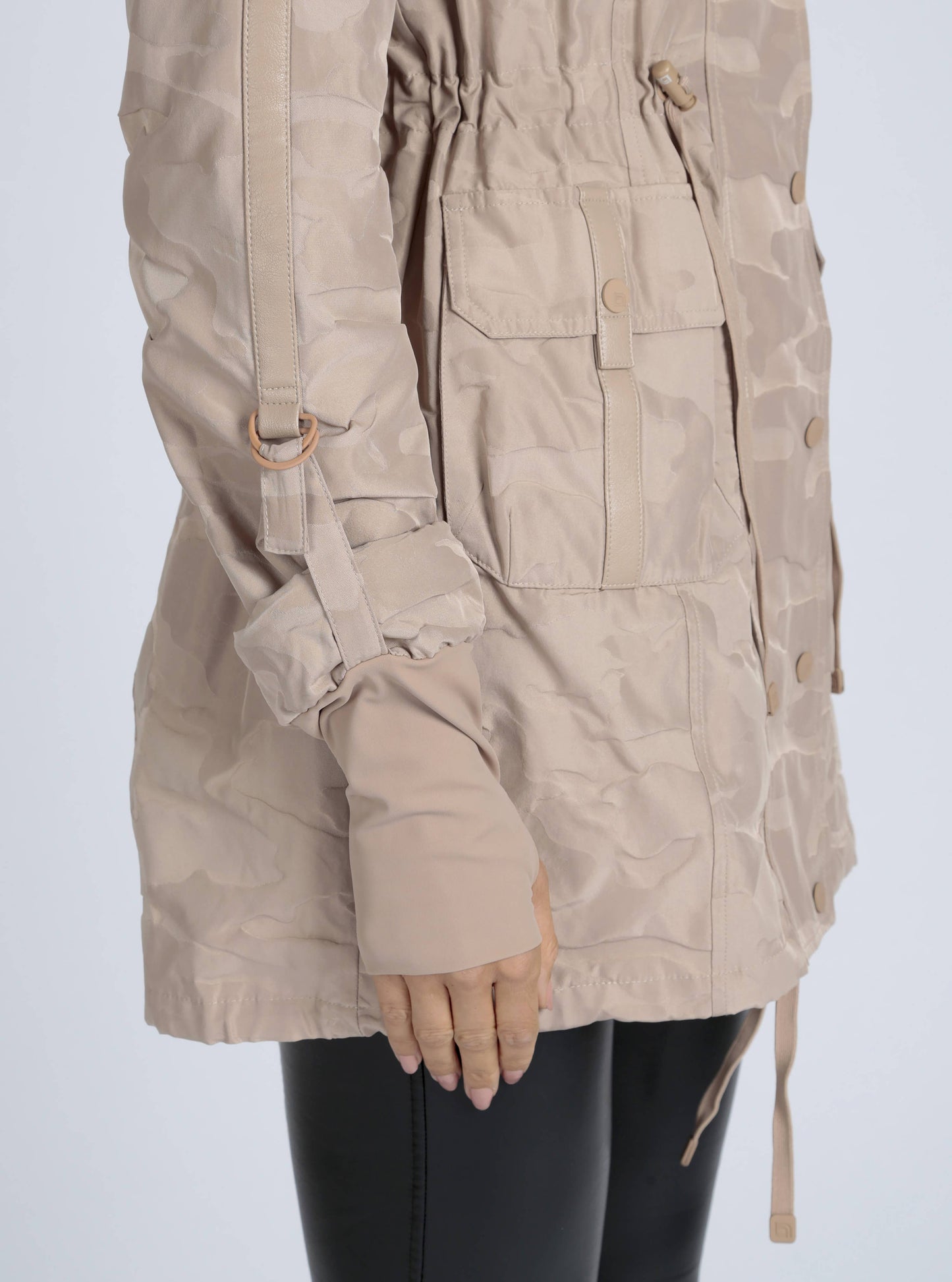 Beige parka jacket worn by a person on a white background