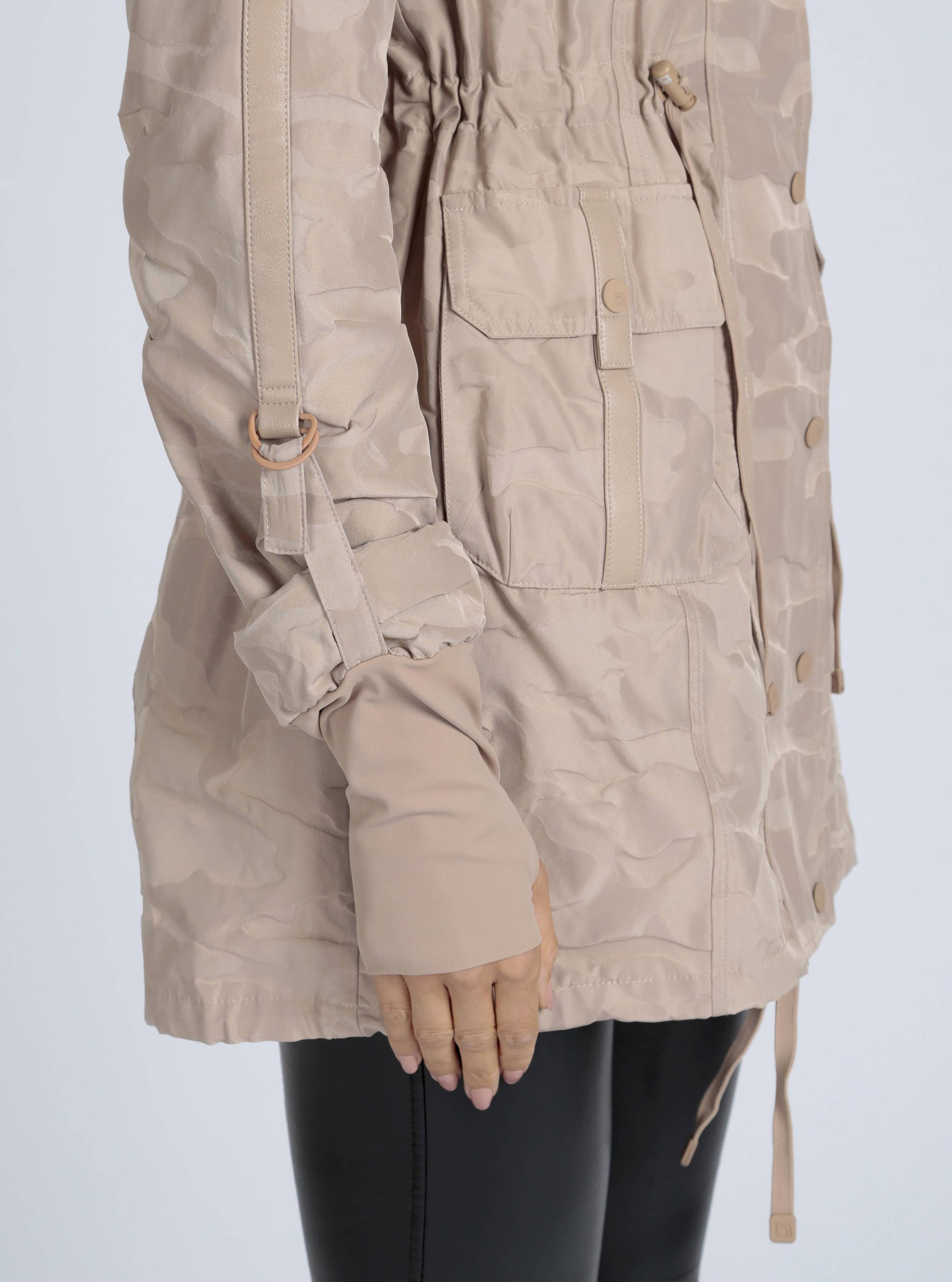 Beige parka jacket worn by a person on a white background