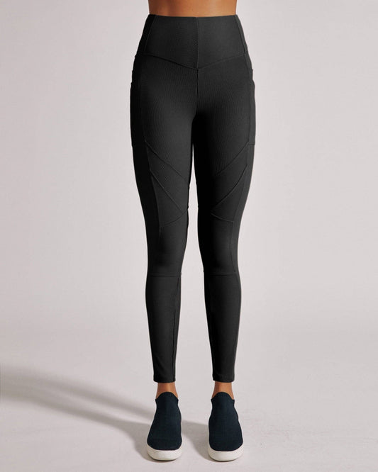Black leggings worn by a person on a light gray background