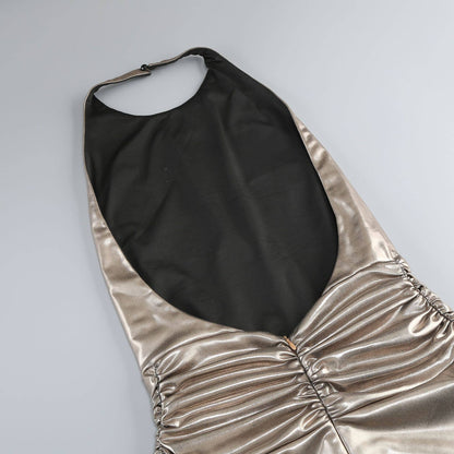 Gold and black halter top on a light gray background