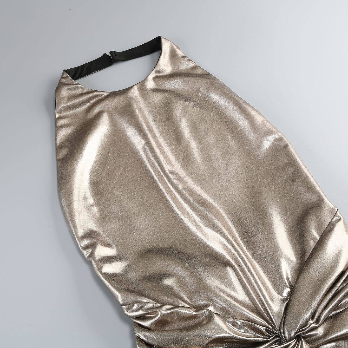 Gold metallic dress on a gray background