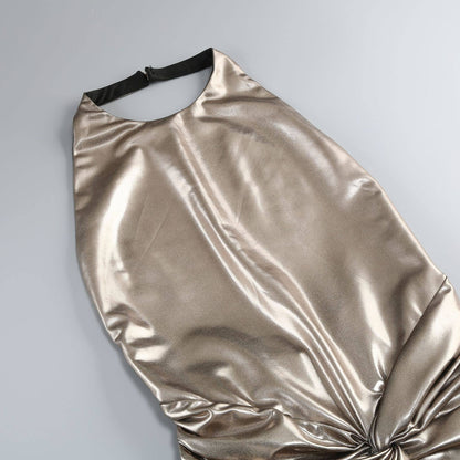 Gold metallic dress on a gray background