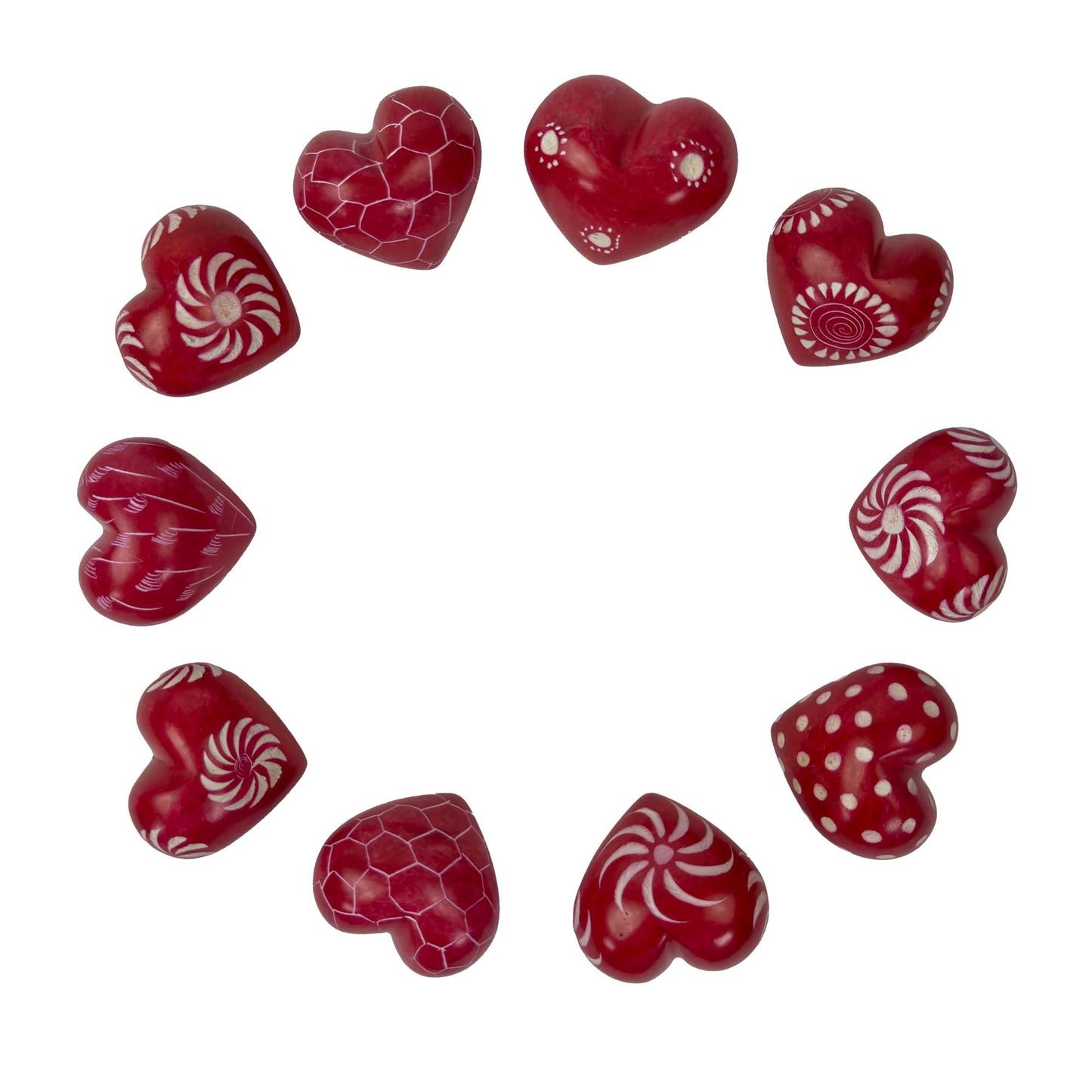 Red heart-shaped candies with white patterns on a white background