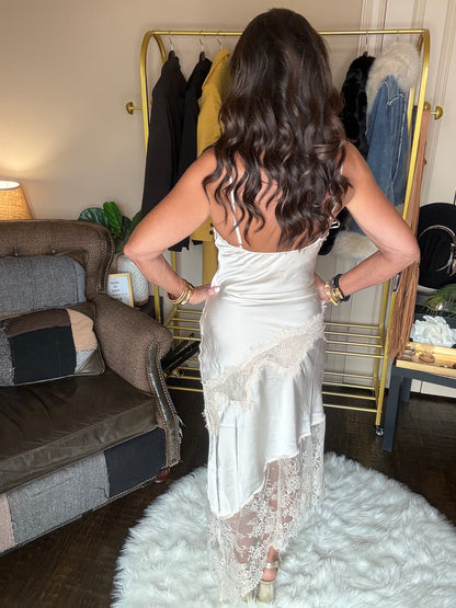 Back view of the pearl satin lace trim maxi dress showing the low back, thin straps and asymmetrical lace skirt.