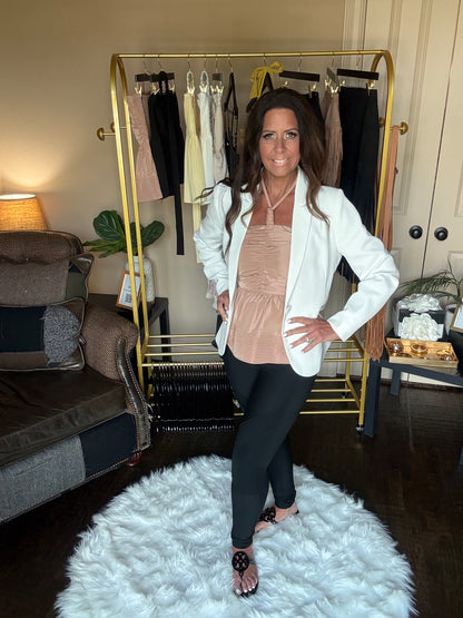 Woman posing in a room with a mirror reflecting her image.