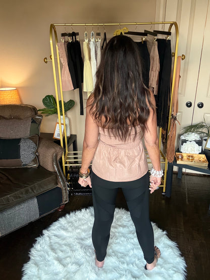 Person standing in a room with a white rug, furniture, and decorative items.