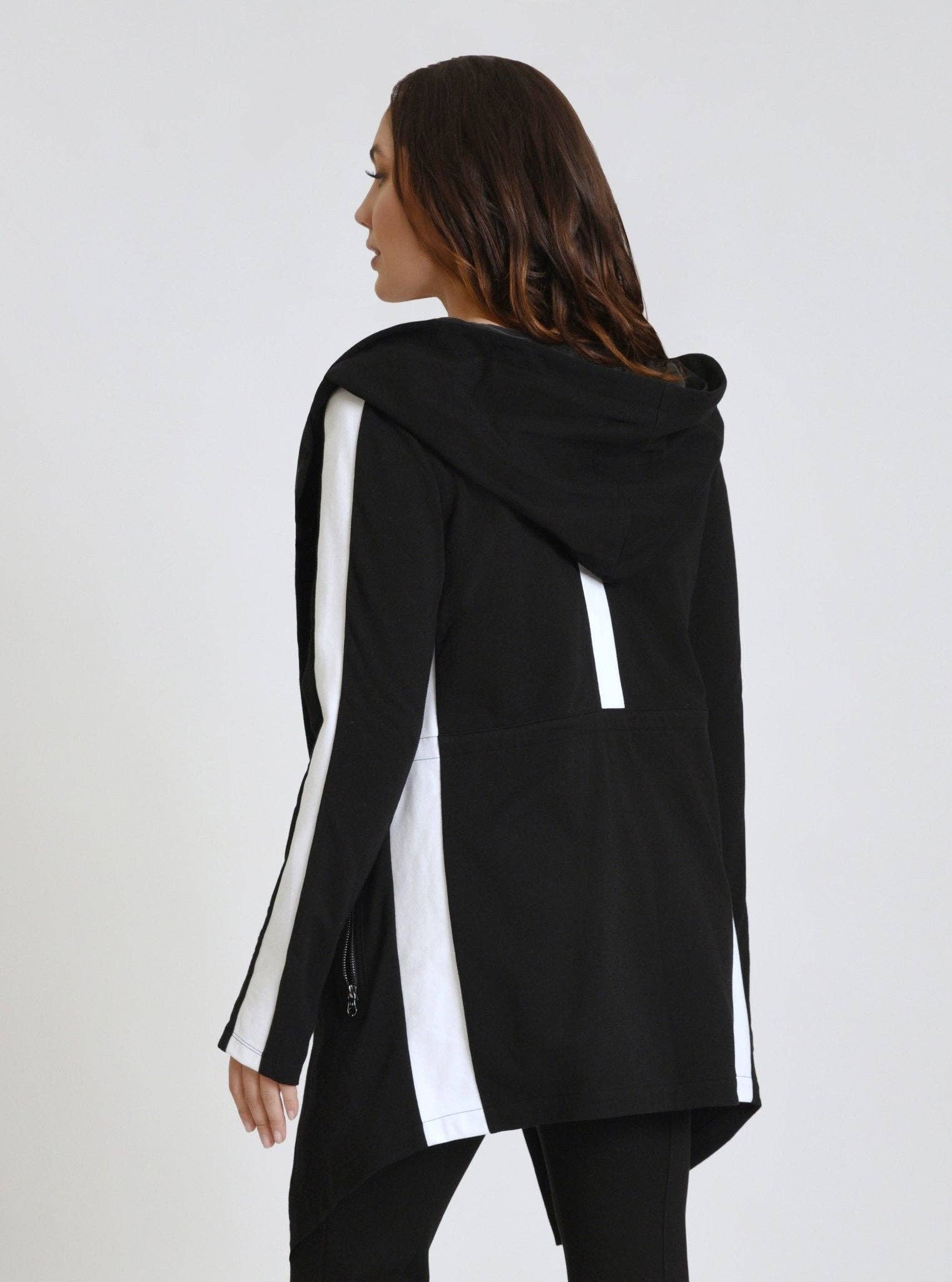 Black hoodie with white accents worn by a person on a white background