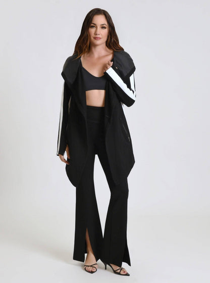 Woman wearing a black outfit with a jacket on a white background