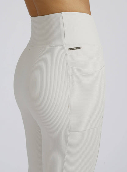 White ribbed leggings with a brand logo on a white background
