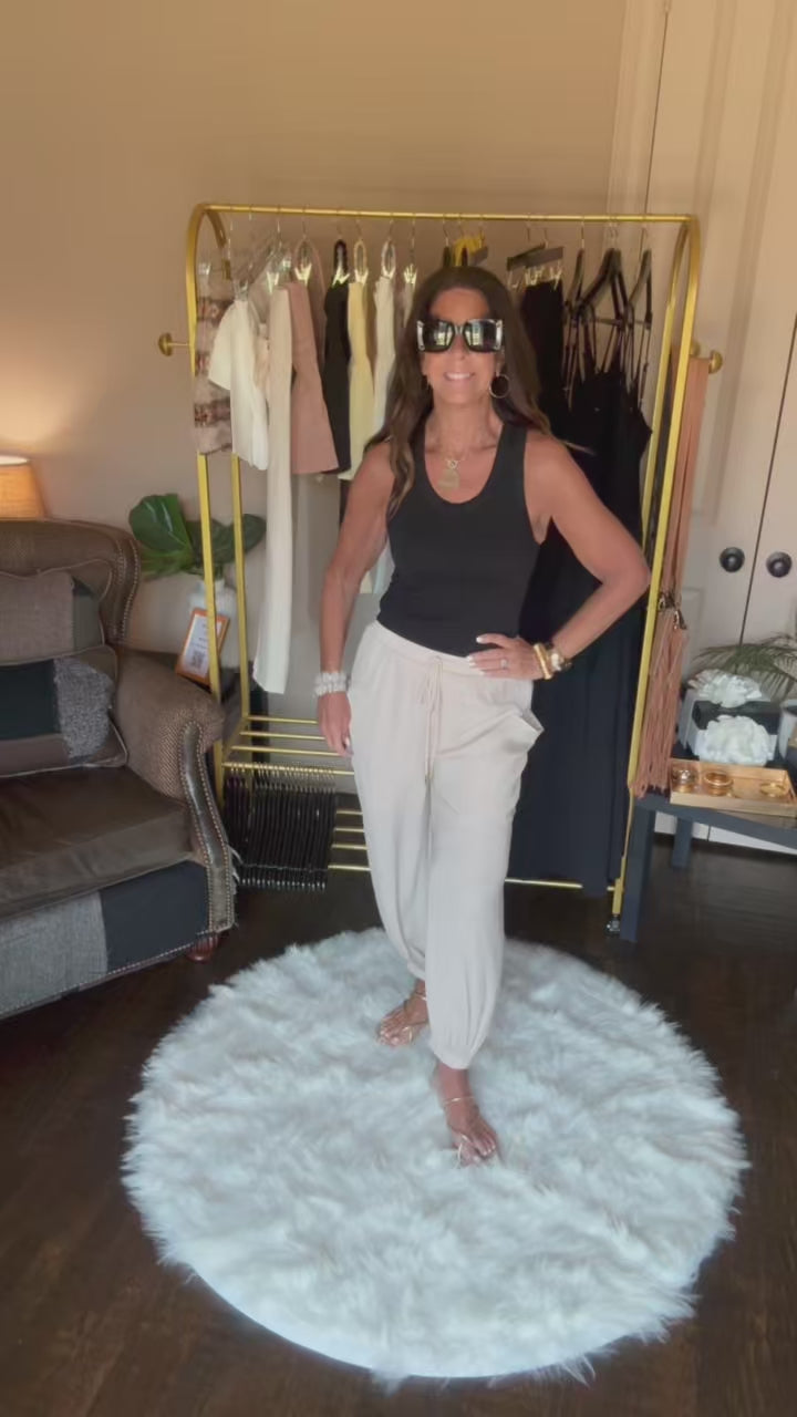 Woman is modeling tan harem pants.