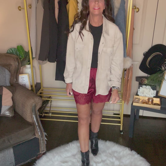 Video of the taupe Perfect Layer Lightweight Tie Blazer worn open over a black top and burgundy lace-trim shorts.