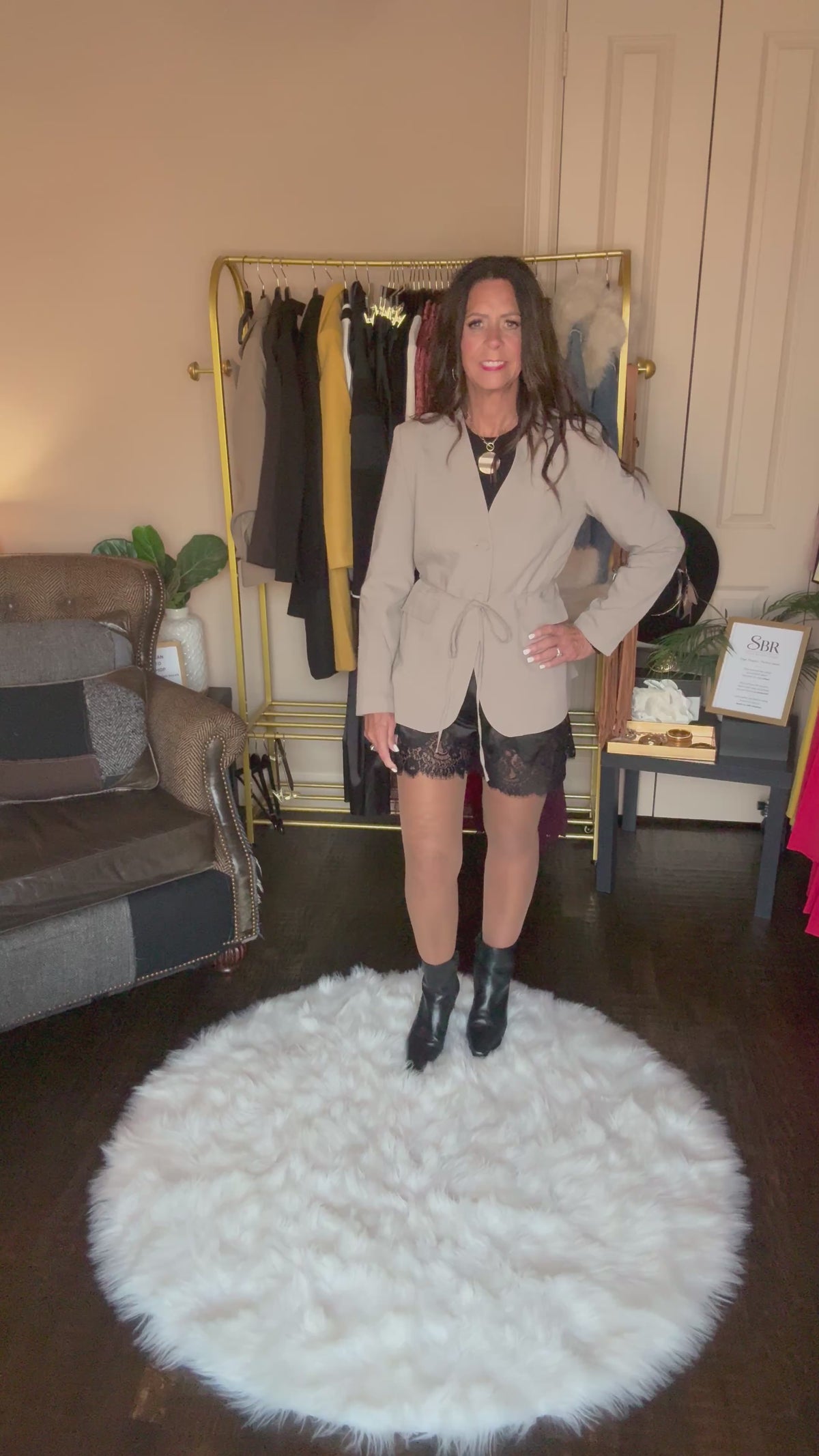 Video of the taupe Perfect Layer Lightweight Tie Blazer with black lace-trim shorts, a necklace and black ankle boots.