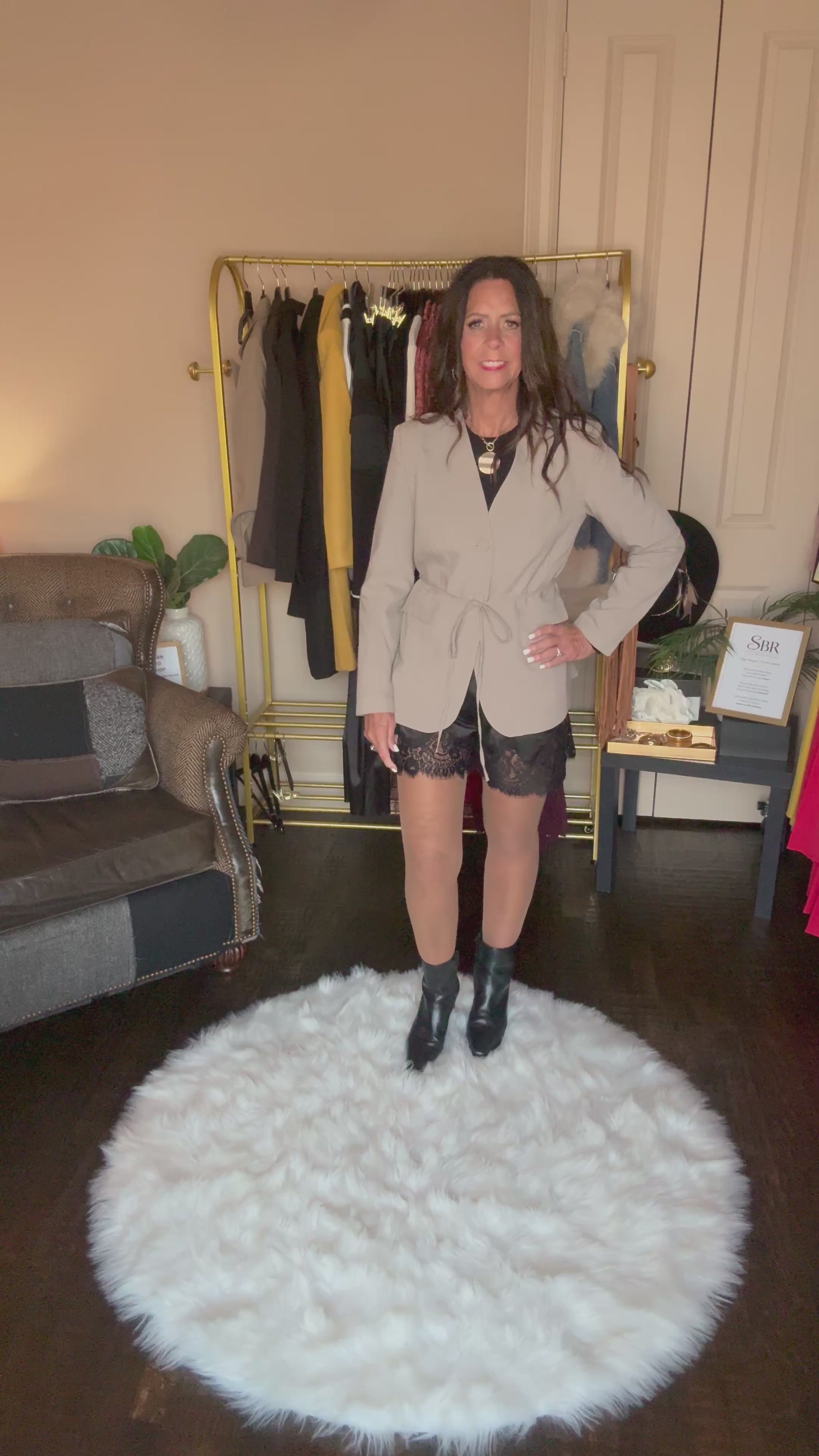 Video of the taupe Perfect Layer Lightweight Tie Blazer with black lace-trim shorts, a necklace and black ankle boots.